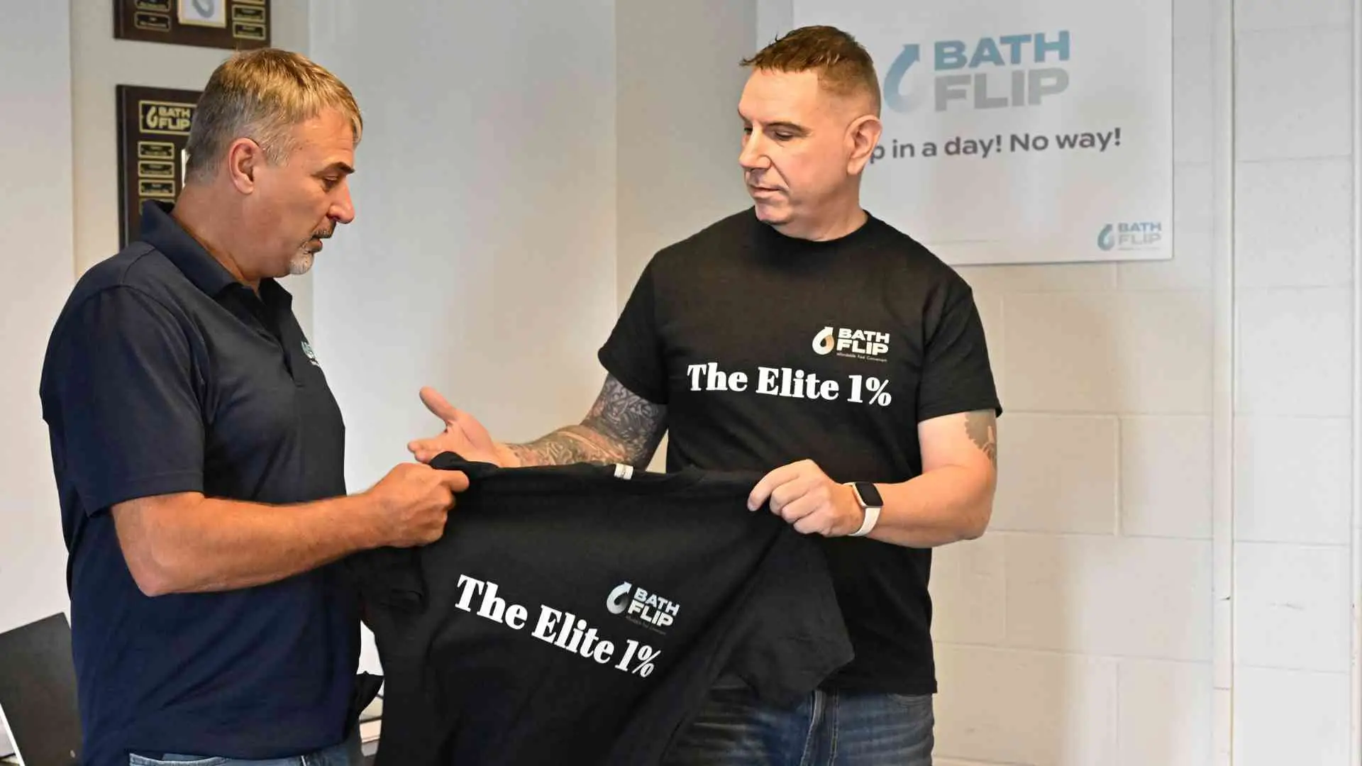 team members handing tee shirt