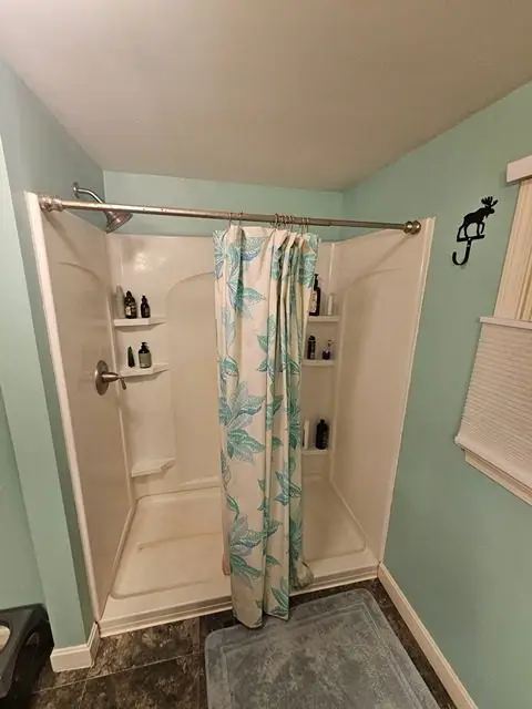 Before bathroom remodel showcasing outdated design and fixtures in need of transformation.