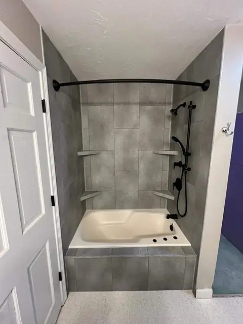 After bathroom remodel featuring modern design, elegant fixtures, and spacious layout.