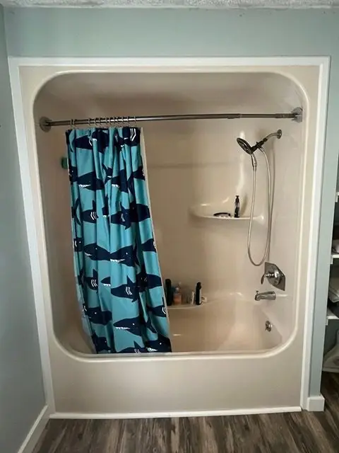 Before image of a bathroom remodel showcasing outdated features and design elements.