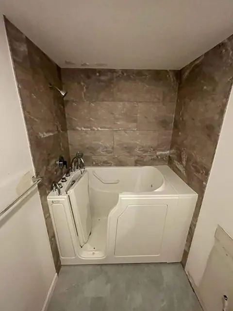After image of a stylish bathroom featuring new tiles and modern fixtures.
