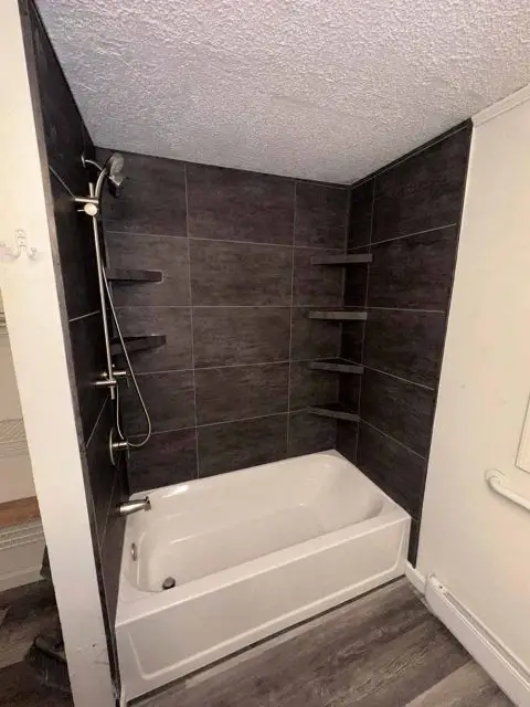 After image of a stylish bathroom remodel featuring a sleek shower and modern vanity.
