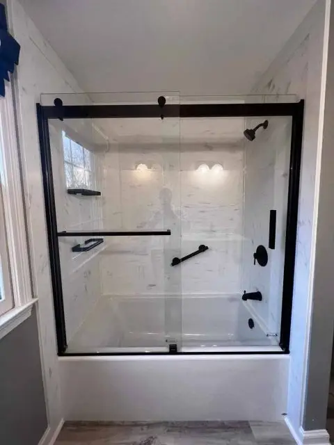 After photo of a beautifully renovated bathroom with contemporary design elements and lighting.