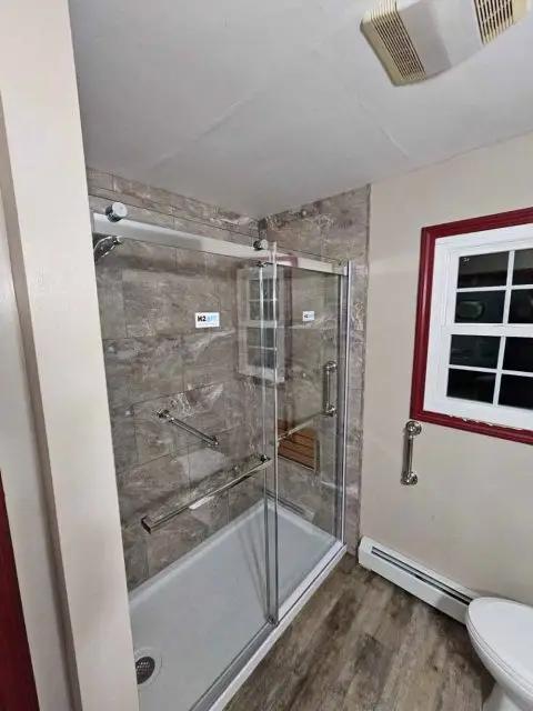 Stunning after photo of a bathroom remodel featuring elegant finishes and modern amenities.