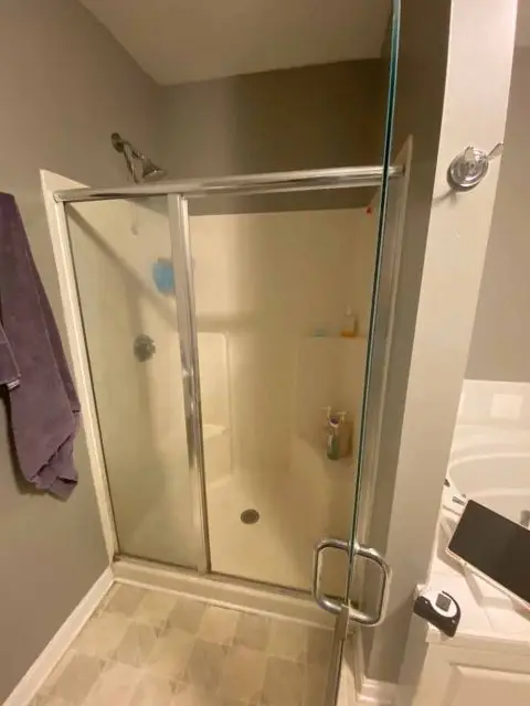 Before renovation image showing an outdated bathroom with minimal appeal and functionality.