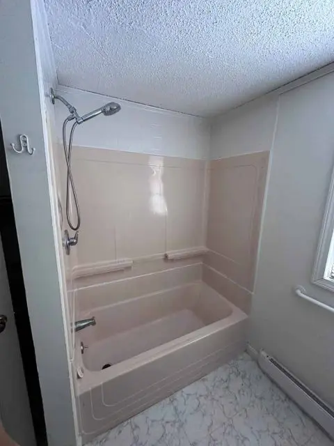 Before image showing an outdated bathroom with old tiles and fixtures.