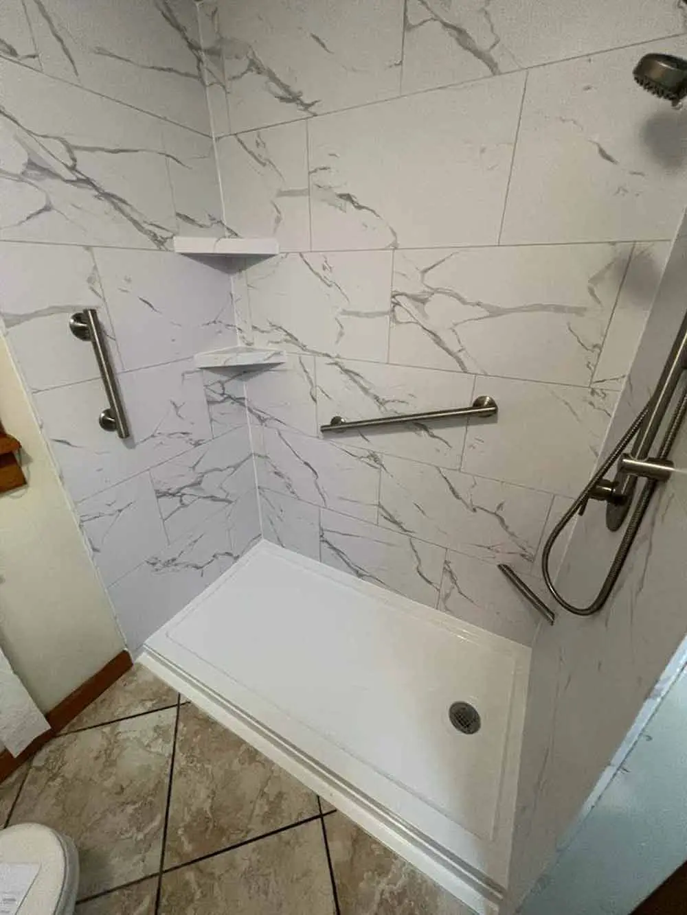 Contemporary shower with a grab bar, perfect for a luxurious bathroom experience.