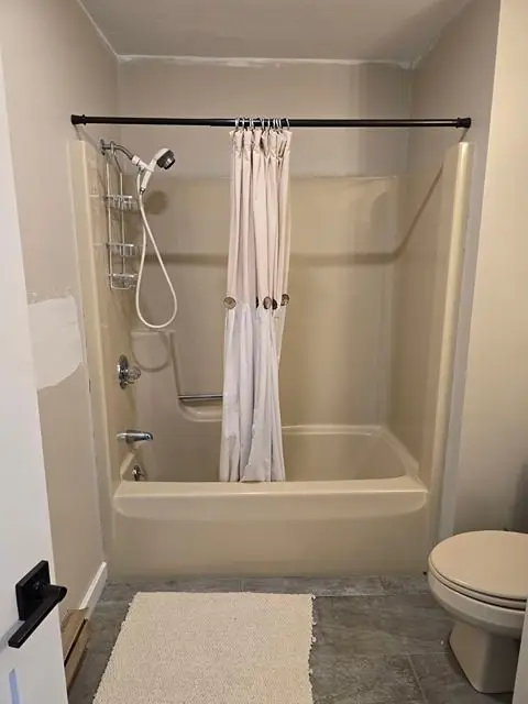 Outdated bathroom before renovation, showing old fixtures and decor.