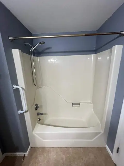 Before image of a bathroom remodel showcasing outdated fixtures and decor.