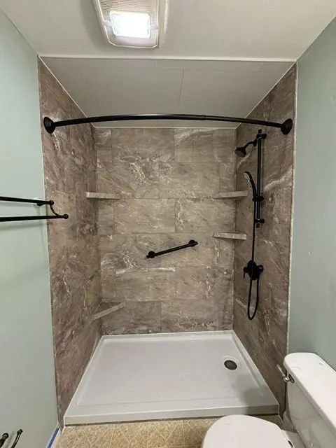 After image of a stylish bathroom featuring elegant tiles and modern amenities.