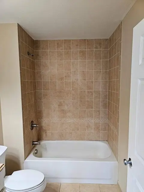 Before image of a dated bathroom with worn-out fixtures and decor.
