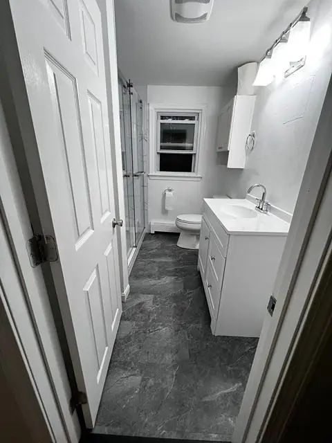 Stunning after photo of a transformed bathroom with elegant fixtures and decor.