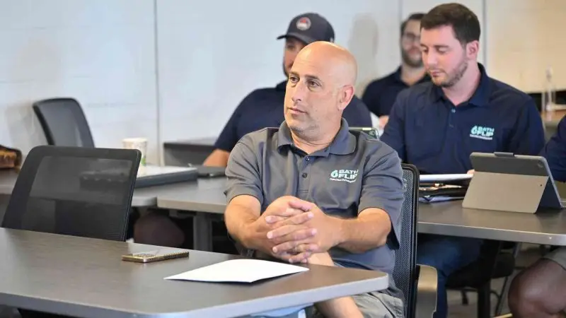 Bath Flip team members engaged in training for exceptional service delivery.